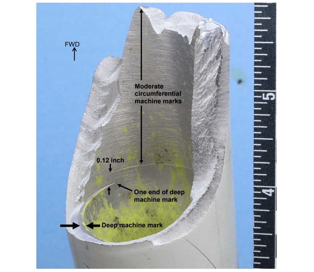 Eclipse Aviation EA500  N508JA MLG:  Side view of the trunnion showing the aft fracture face. The fatigue crack emanated from multiple origins at a deep machining mark on the inner upper surface (Credit: NTSB)