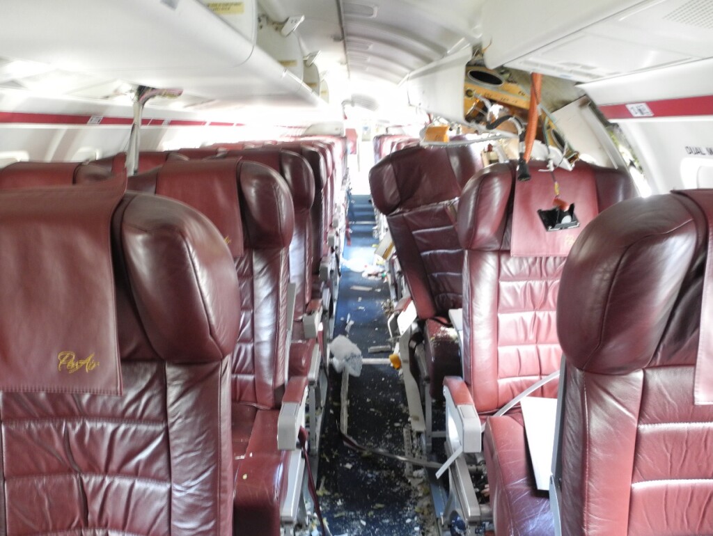 PenAir Saab 2000 N686PA Unalaska, with Displaced Seat 4A (location of fatality) and Yellow Arrow Marking the Blade at Seat 4G (Credit: NTSB)
