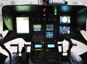 EC135 Cockpit: The large display on the left is  operated by the HEMS crew member. He can  choose to view the  moving map on the entire display, as shown in the picture, or to split the display, as shown for the pilot on the right. A third possibility is that the display on the left shows flight instruments on the top half and the moving map on the lower half of the display (Credit: AIBN)