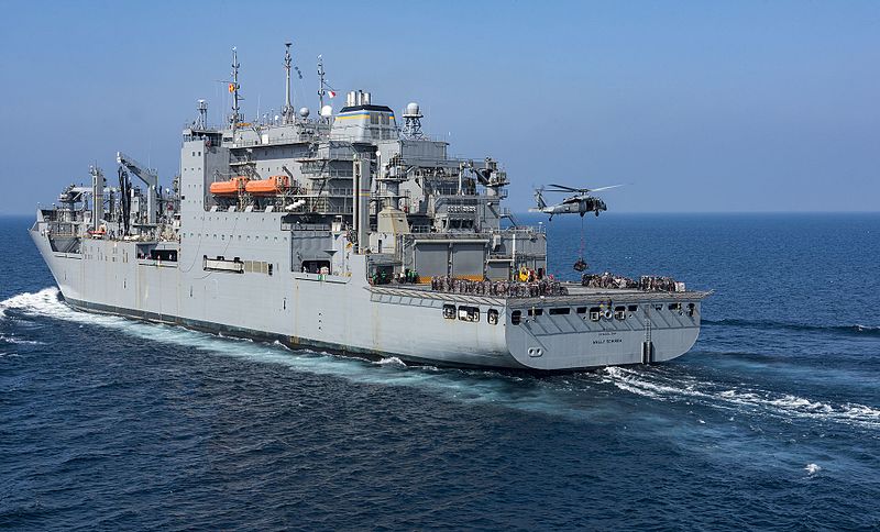 Lewis and Clark-class dry cargo and ammunition ship USNS Wally Schirra (T-AKE 8) in the Pacific in 2017 with a MH-60S Sea Hawk under taking VERTREP (Credit: US Navy / Mass Communication Specialist 2nd Class Sean M. Castellano)