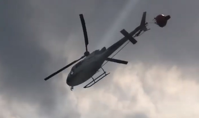 Hélilagon Airbus AS350B3e / H125 Trailing its Bambi Bucket after an Impact with its Tail Rotor while HESLO Fire-Fighting at the Piton de la Fournaise Volcano, Réunion (Credit: YouTube Video Posted by BK117)